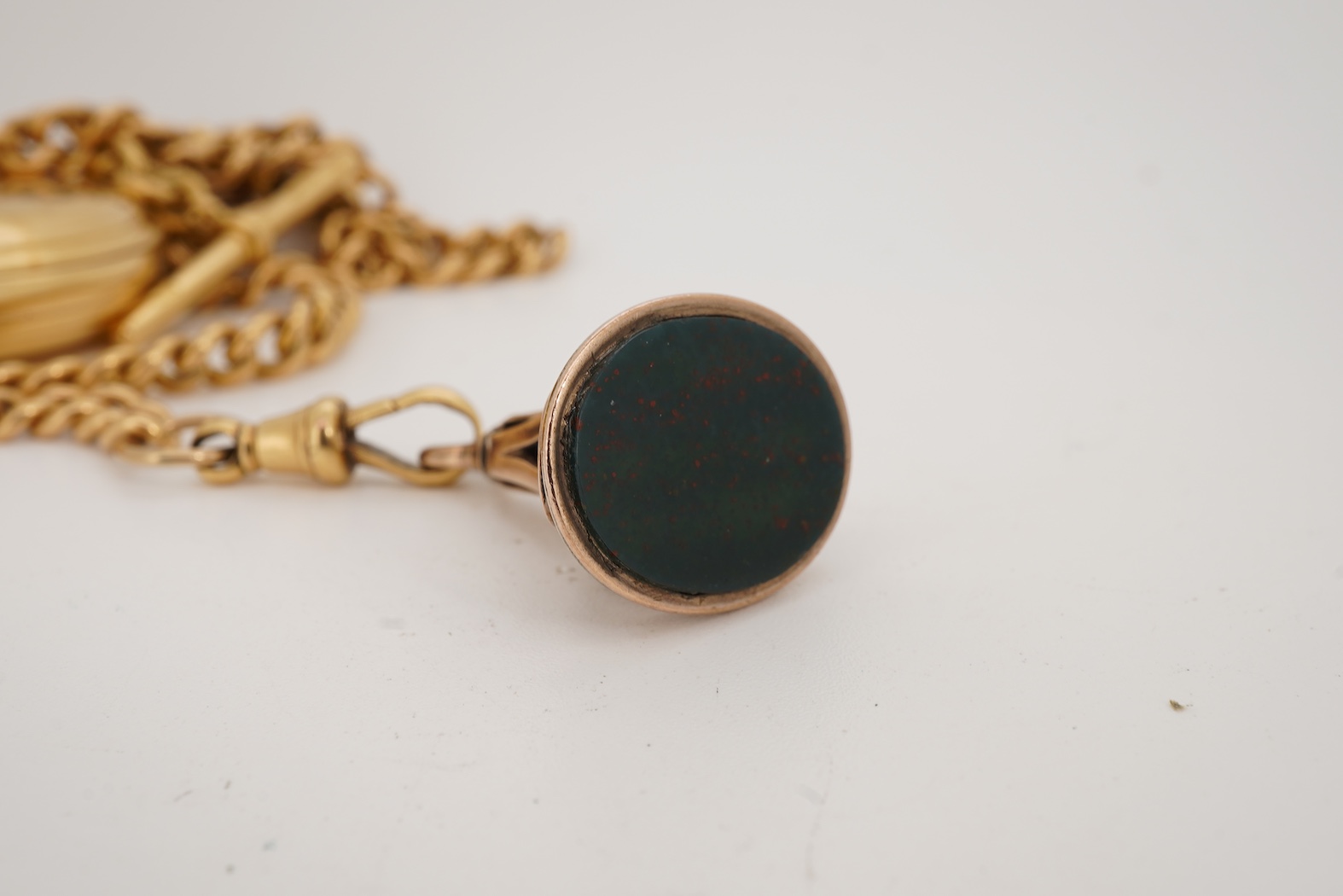 A late Victorian 18ct gold half hunter quarter repeating keyless lever pocket watch, by Alexander Guillaume, Spencer St, Northampton Sq. London, together with a similar 18ct gold curb link albert, hung with a yellow meta